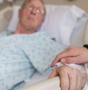 holding hands with elderly patient at hospital