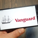 Hand holding smartphone with Vanguard on screen