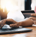Person online shopping using rewards credit card