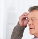 Older man looking at calendar confused