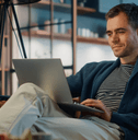 Young man looking at online banking on laptop