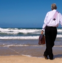 man looking gazing in thought out to sea