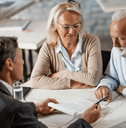 Financial advisor sitting with older couple