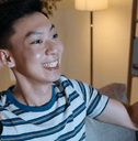 Young man watching tv with lottery ticket in hand