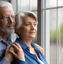 Senior couple looking through the window