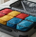 organized suitcase with colorful packing cubes on a bed