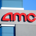 AMC sign, logo advertises AMC movie theater on a sunny day under blue sky 