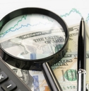 Cash with a yield graph, magnifying glass, calculator, and pen