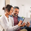 Couple on couch with tablet