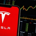 Smartphone Displays Tesla Logo (TSLA Shares) Stock Market Chart