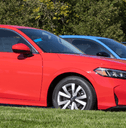 Honda civics in line at dealership outside