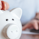 Man putting coins in piggy bank