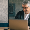 Man on laptop looking at banking options