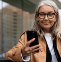 Woman sitting on bench checking online banking