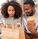 Couple eating takeout food at home
