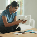 Young woman going over receipts to save money