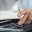 Woman reviewing finances with calculator
