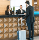 Man checking into hotel at front desk
