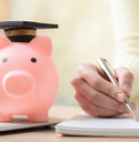 Woman playing tuition savings with piggy bank and laptop