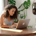 Woman at home checking banking on laptop