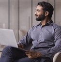 Young man thinking about his banking options with laptop