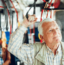 Senior man riding public bus