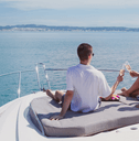 Wealthy couple drinking champagne on yacht