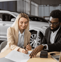 Woman signing papers to buy new car