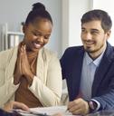 Couple signing home loan paperwork