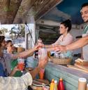 waitress and waiter giving juice to customer at counter