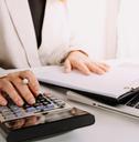 bookkeeper using calculator counting taxes fees