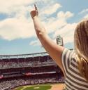 woman standing and cheering at a baseball game