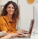 female colleagues interacting while working in office