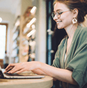 A woman types on her laptop.
