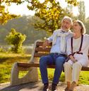 senior couple relaxing on outdoor bench