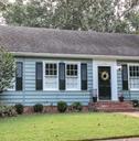 old blue cottage style house with sidewalk