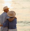older couple hugging on a beach
