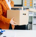 woman at the office carrying her personal stuff