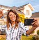 Woman taking a selfie with her new house keys