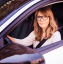 person in their car