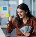 happy young businesswoman holding money