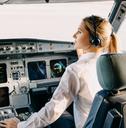 woman pilot sitting in airplane cockpit