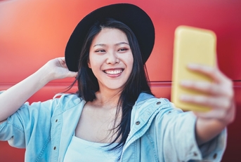 Happy woman taking selfie