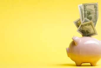 Piggy bank isolated on yellow background.