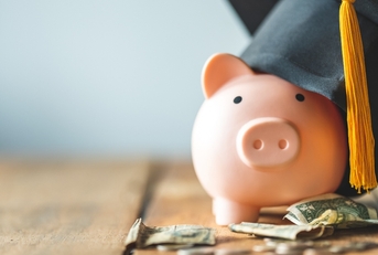 piggy bank wearing graduation cap
