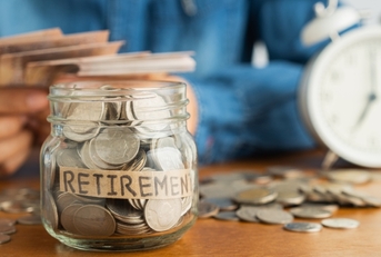 Jar filled with coins labeled retirement 