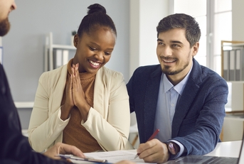 Couple signing home loan paperwork