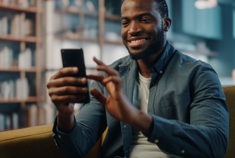 Man smiling and looking at phone