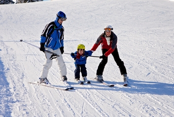 Family with young child skiing