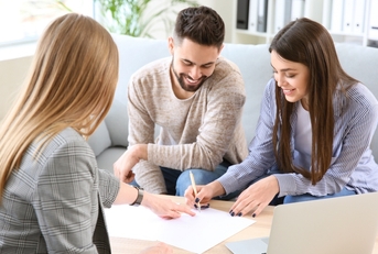 Couple signing loan paperwork
